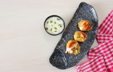 Sabudana vada or Sago fried fitters served with Curd or yogurt and ketchup over white wooden...