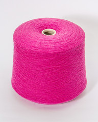 Green bobbin of yarn on a white background.Textile reel on isolated white background.