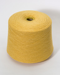 Green bobbin of yarn on a white background.Textile reel on isolated white background.