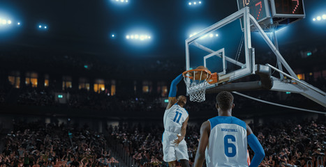 Basketball players on big professional arena during the game. Tense moment of the game. Celebration