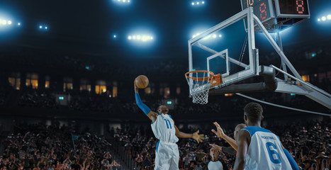 Basketball players on big professional arena during the game. Tense moment of the game. Celebration
