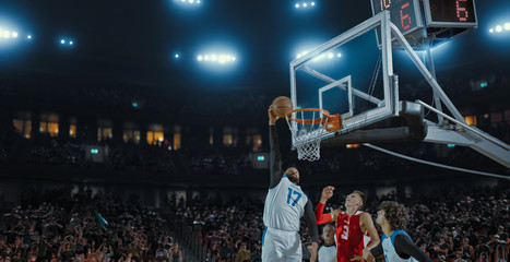 Basketball players on big professional arena during the game. Tense moment of the game. Celebration