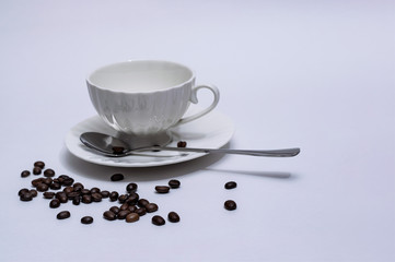 white empty coffee Cup with beans and a spoon