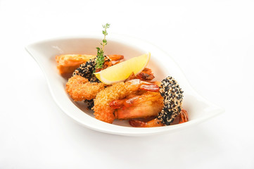 Shrimp in a restaurant close-up. Tiger prawns breaded on a white plate and copy space.