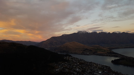 Fototapeta na wymiar Looking down at Queenstown with beautiful lake from top of mountain
