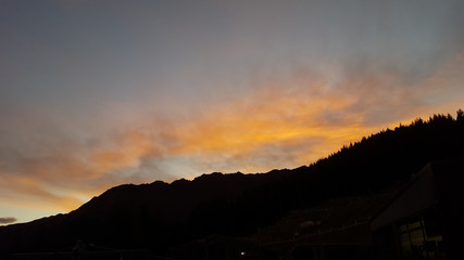 Fototapeta premium Looking down at Queenstown with beautiful lake from top of mountain