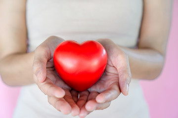 woman hand holding red heart healthy ,donation,love concept 