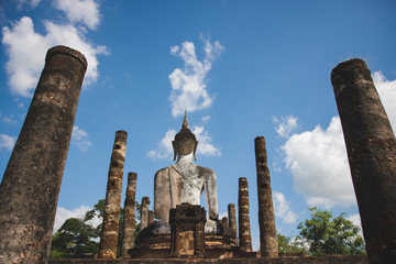 Buddha statue and pagoda in Sukhothai historical park, world heritage site in Thailand.