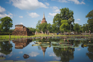Buddha statue and pagoda in Sukhothai historical park, world heritage site in Thailand.