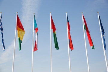 Flags of different countries against the sky