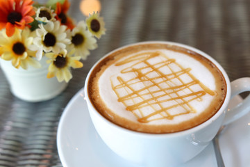 hot caramel macchiato coffee drink put on table in cafe