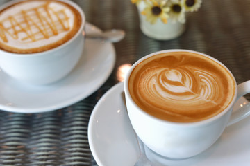 hot caramel macchiato and latte coffee drink put on table in cafe