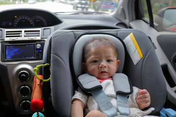 cute baby boy excited sitting on car seat safety drive road trip travel