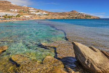 Summertime. Mykonos: Paradise beach (Kalamopodi),Greece. Sunny with blue sky and crystal clear water. Paradise is definitely the most famous beach of Mykonos: thin sand and emerald green water.