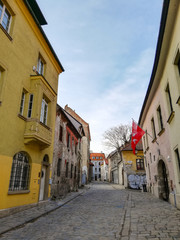 Fototapeta na wymiar A beautiful typical paved street in Bratislava's Old Town district. June 2019, Slovakia. Sunny day in the capital. Interesting architecture and building facades.