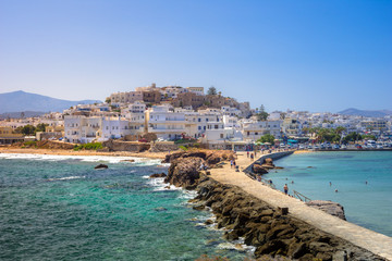 Chora of Naxos island as seen from the famous landmark the Portara with the natural stone walkway towards the village, Cyclades, Greece. - obrazy, fototapety, plakaty