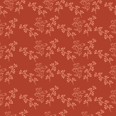 Seamless pattern of twigs and leaves on a brick color background. Vector graphics.