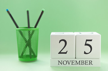 Desk calendar of two cubes for November 25