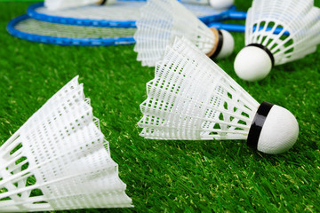 Badminton game rackets and shuttlecock on grass