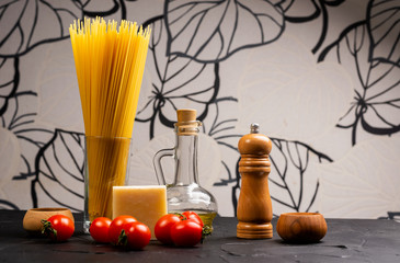 italian food ingredients for cooking pasta raw spaghetti fusilli tagliatelle fresh tomatoes mushrooms onion parsley garlic olive oil on wooden background top view