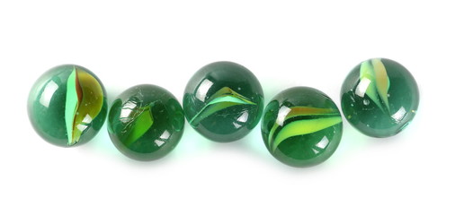 Green glass marbles, isolated on white background, top view