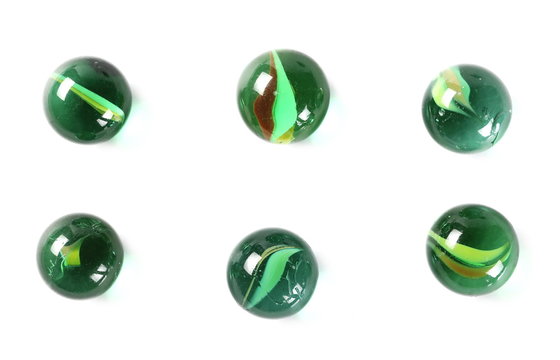 Green glass marbles, isolated on white background, top view