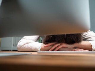 Tired female employee at office workplace taking nap