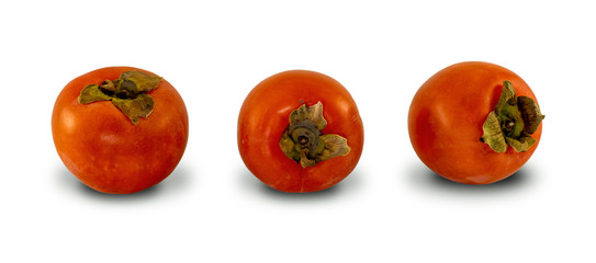 Three fresh persimmon fruits, isolated on white background