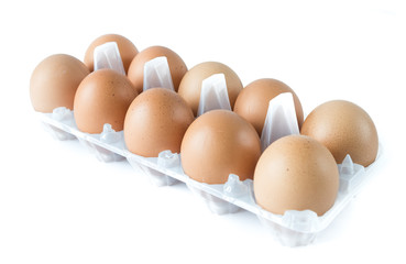 Studio shot a plastic tray with ten pastured raised chicken eggs isolate on white