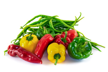 Pile of different type and color peppers. Red jalapeno peppers, long green peppers and different color bell peppers.