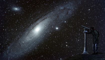 One person watches the starry sky at night. The Andromeda galaxy shines large in the night sky....
