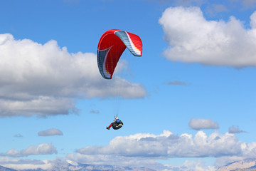 Paraglider flying wing in a blue sky	