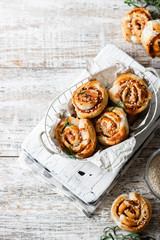 Unsweetened snails and puff pastry with bacon, sesame seeds and rosemary.