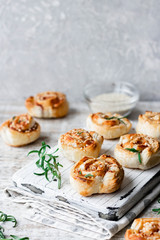 Unsweetened snails and puff pastry with bacon, sesame seeds and rosemary.