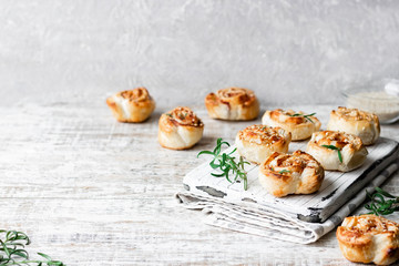 Unsweetened snails and puff pastry with bacon, sesame seeds and rosemary.