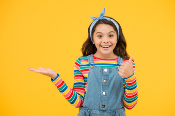 old fashioned kid fashion. little beauty handkerchief long hair. vintage style. happy childhood. retro girl cheerful gesture. summer vacation joy. little child yellow background. presenting product