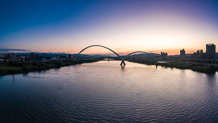 Crescent Bridge - landmark of New Taipei, Taiwan with beautiful illumination at day, aerial photography in New Taipei, Taiwan.