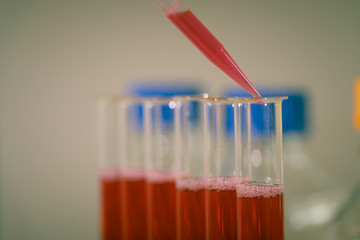Test tube in rack and pipette media dispenser.