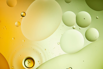 Beautiful abstract background from mixed water and oil in green and orange color