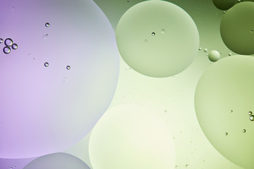 creative abstract background from mixed water and oil in light green and purple color