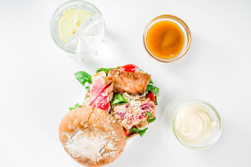 Various seafood and fish burgers assortment. Homemade healthy burger with grilled prawn, salmon, tuna, sea bass, fresh herbs, mozzarella cheese and baby spinach.