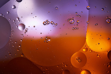 Beautiful abstract background from mixed water and oil in orange and purple color