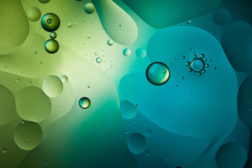 abstract background from mixed water and oil in blue and green color