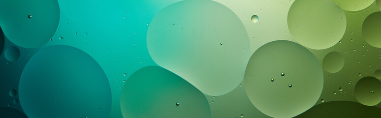 panoramic shot of Beautiful abstract background from mixed water and oil in turquoise and green...