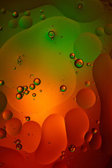 green and red color abstract background from mixed water and oil bubbles
