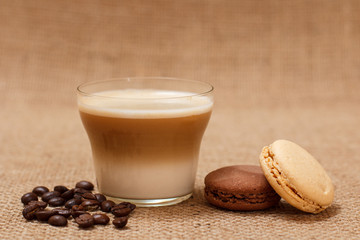 Coffee cappuccino and coffee beans on sackcloth background