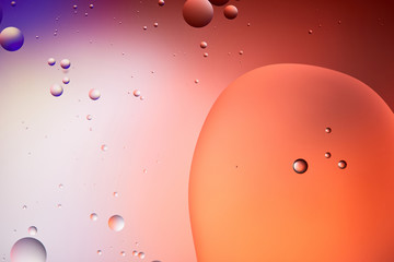 Beautiful abstract background from mixed water and oil bubbles in red and purple color