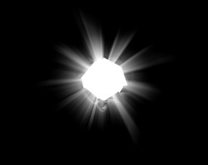 An isolated round hole in black paper with torn edges and piercing sunlight and rays through it. Sunlight breaking through the darkness from a hole.