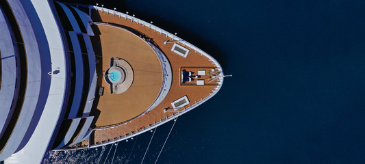 Aerial drone ultra wide top down photo of cruise liner ship docked in Mediterranean port with deep blue sea