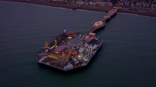 Brighton Seafront and Pier Illuminated at Night Aerial View